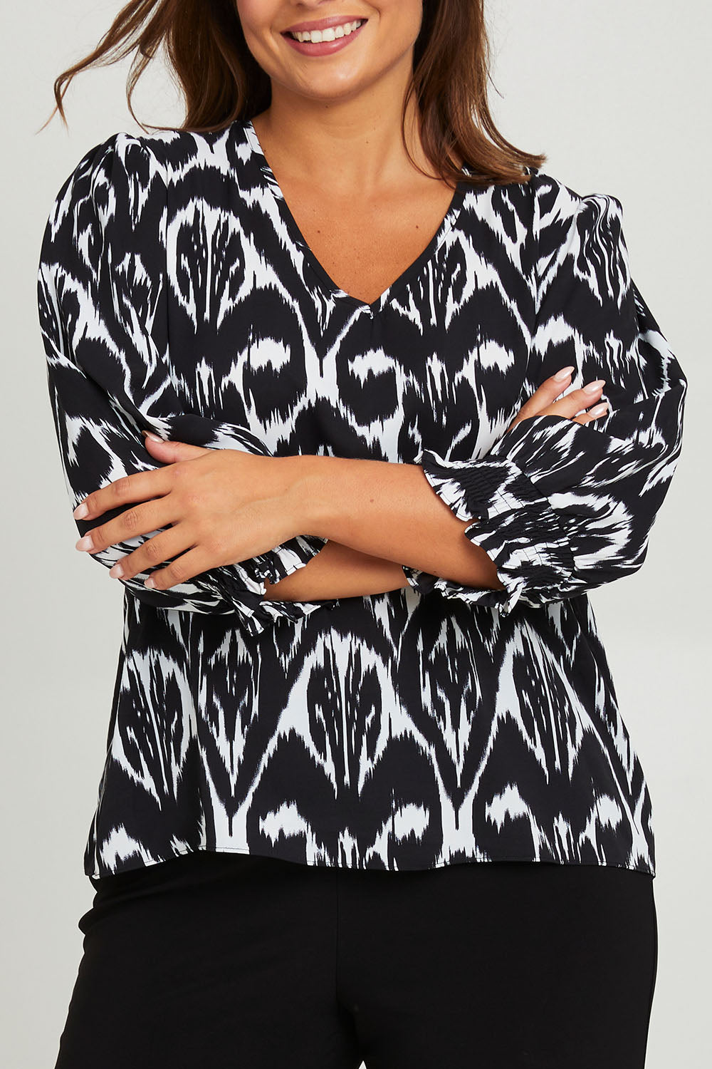 Model Monique wearing size 14 of the Felicia Top in colour Aztec (Blue), from the front, cropped image