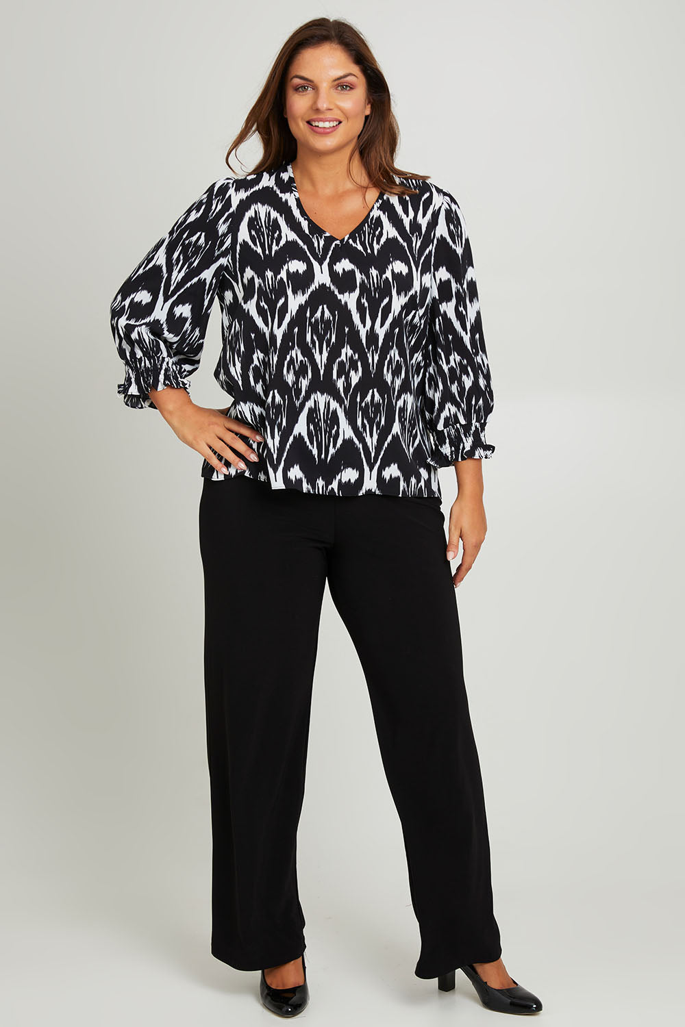 Model Monique wearing size 14 of the Felicia Top in colour Aztec (Blue), from the front, showing the whole outfit