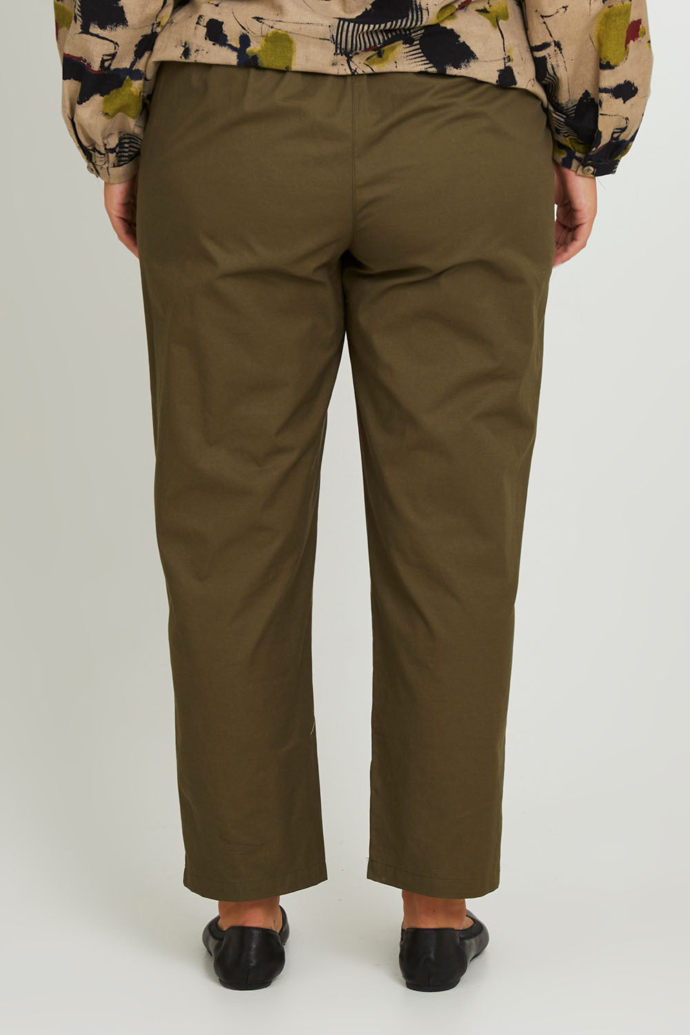 Model Monique wearing size 14 of the Cotton Cargo Pant in colour Khaki (Green), from the back