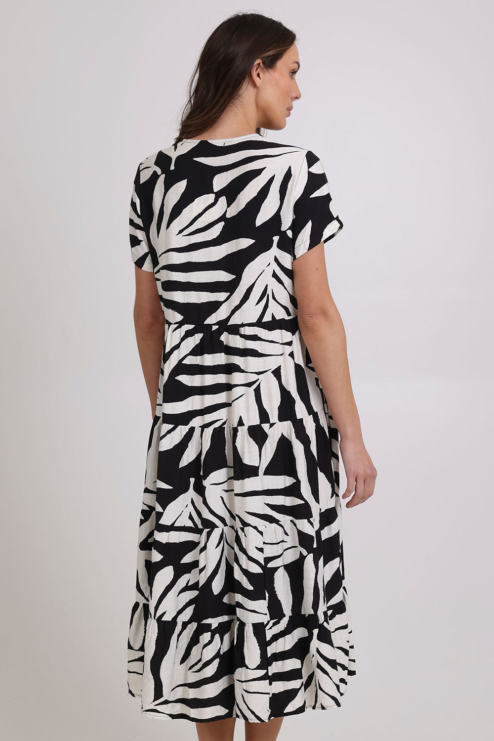 Model Madeline wearing size 10 of the Tier Garden Dress in colour Black (Black), from the back