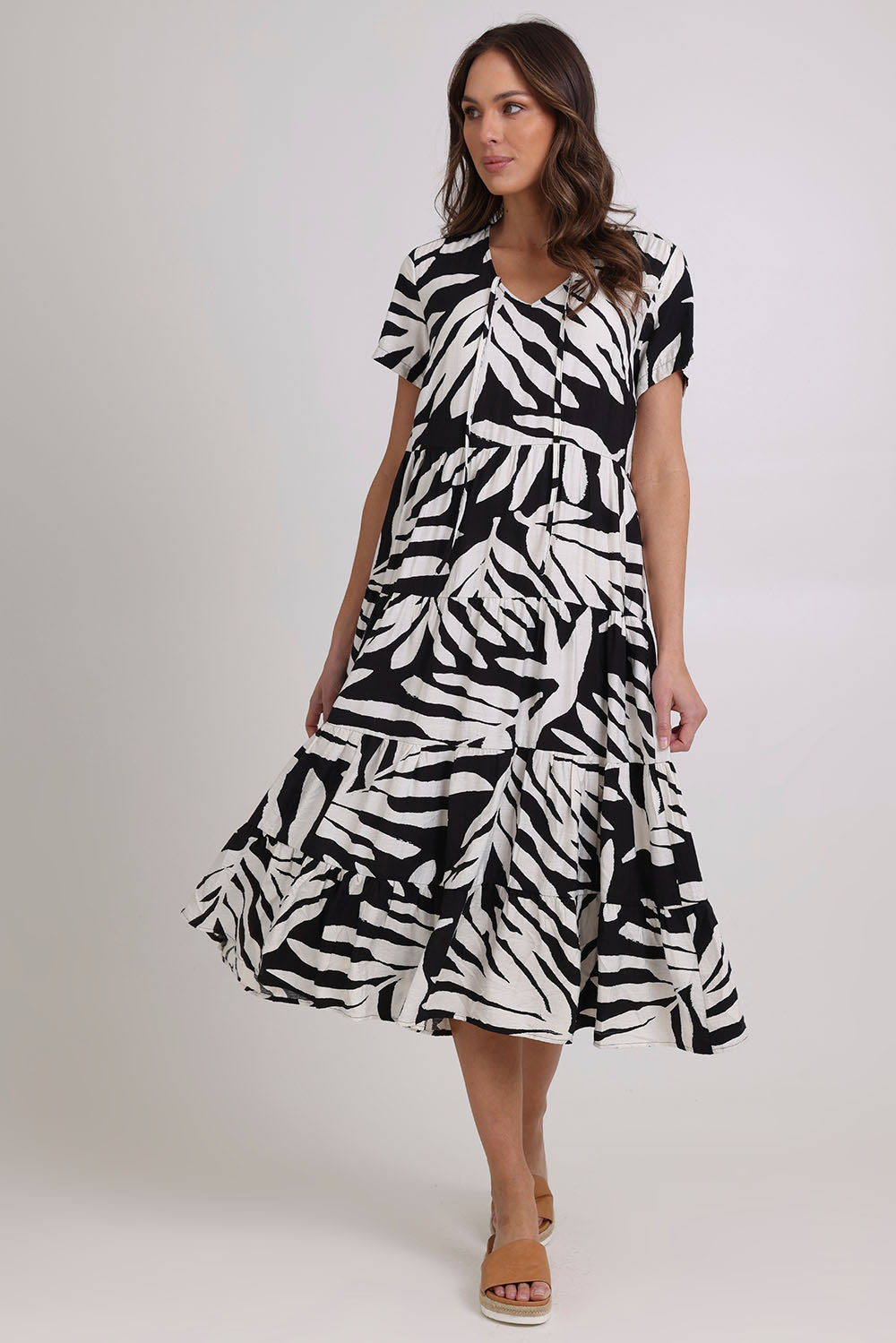 Model Madeline wearing size 10 of the Tier Garden Dress in colour Black (Black), from the front, showing the whole outfit