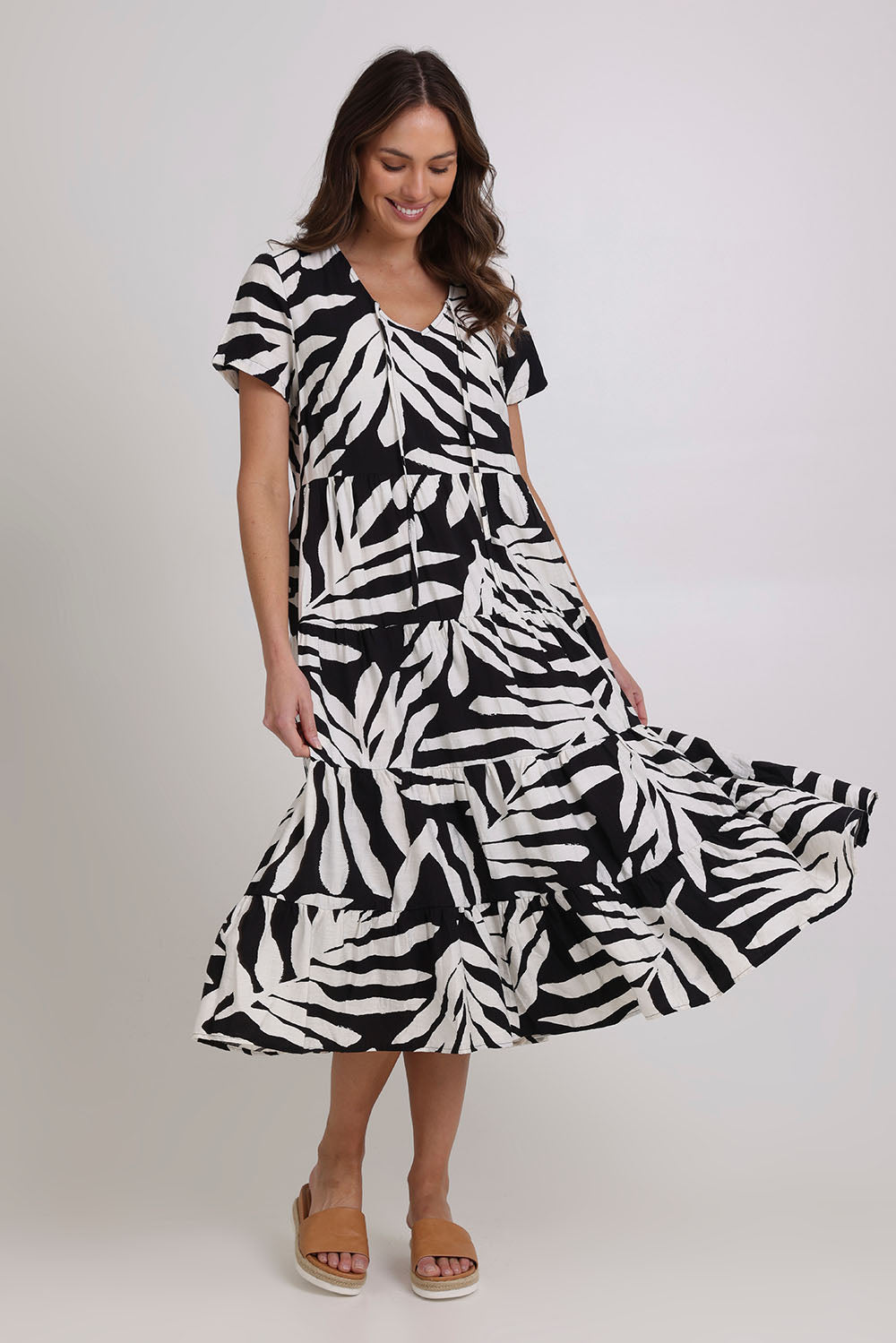 Model Madeline wearing size 10 of the Tier Garden Dress in colour Black (Black), from the front, showing the whole outfit