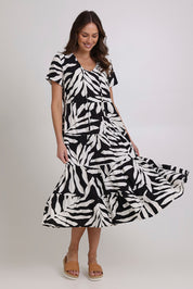 Model Madeline wearing size 10 of the Tier Garden Dress in colour Black (Black), from the front, showing the whole outfit
