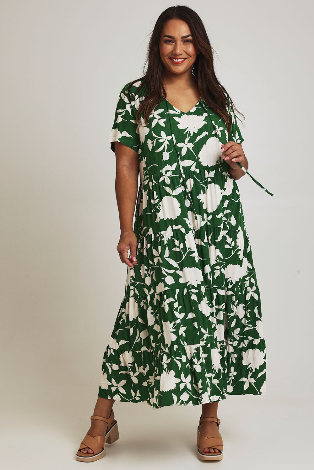 Model Ashleigh wearing size 16 of the Tier Garden Dress in colour Green (Green), from the front, showing the whole outfit