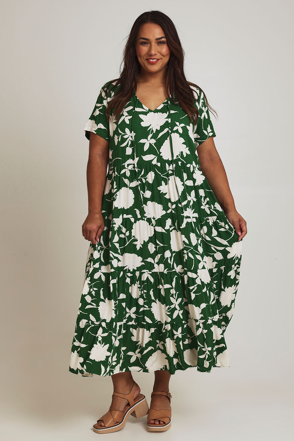 Model Ashleigh wearing size 16 of the Tier Garden Dress in colour Green (Green), from the front, showing the whole outfit