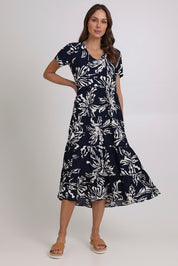 Model Madeline wearing size 10 of the Tier Garden Dress in colour Navy (Blue), from the front, showing the whole outfit
