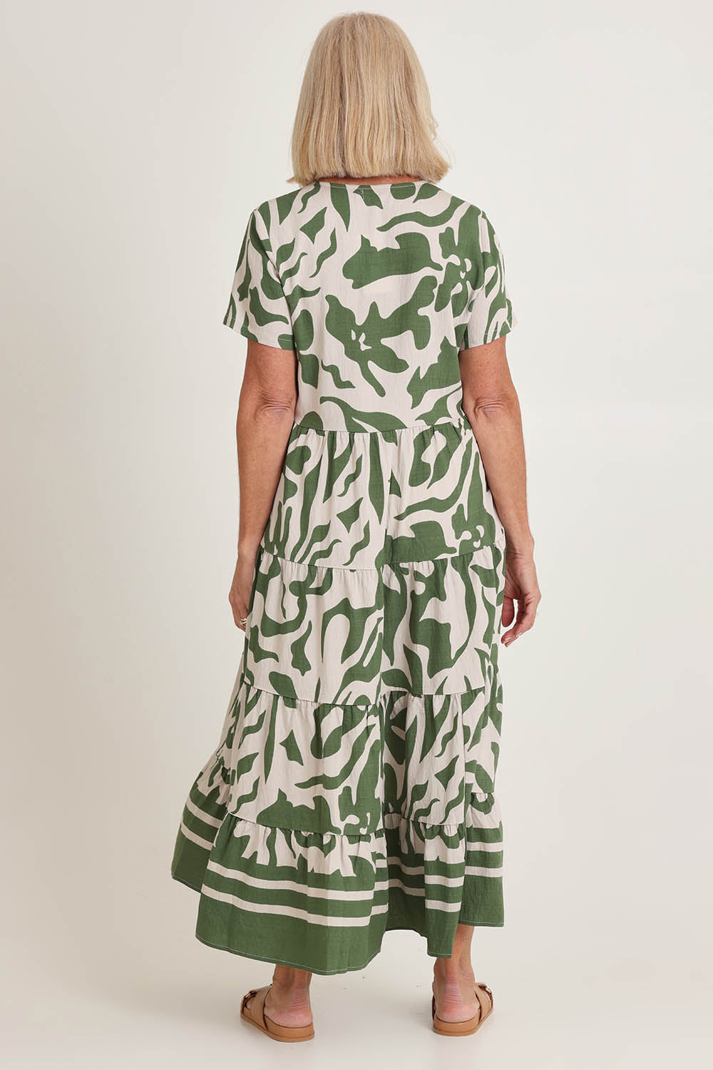 Model Sandy wearing size 10 of the Border Tier  Dress in colour Green (Green), from the back