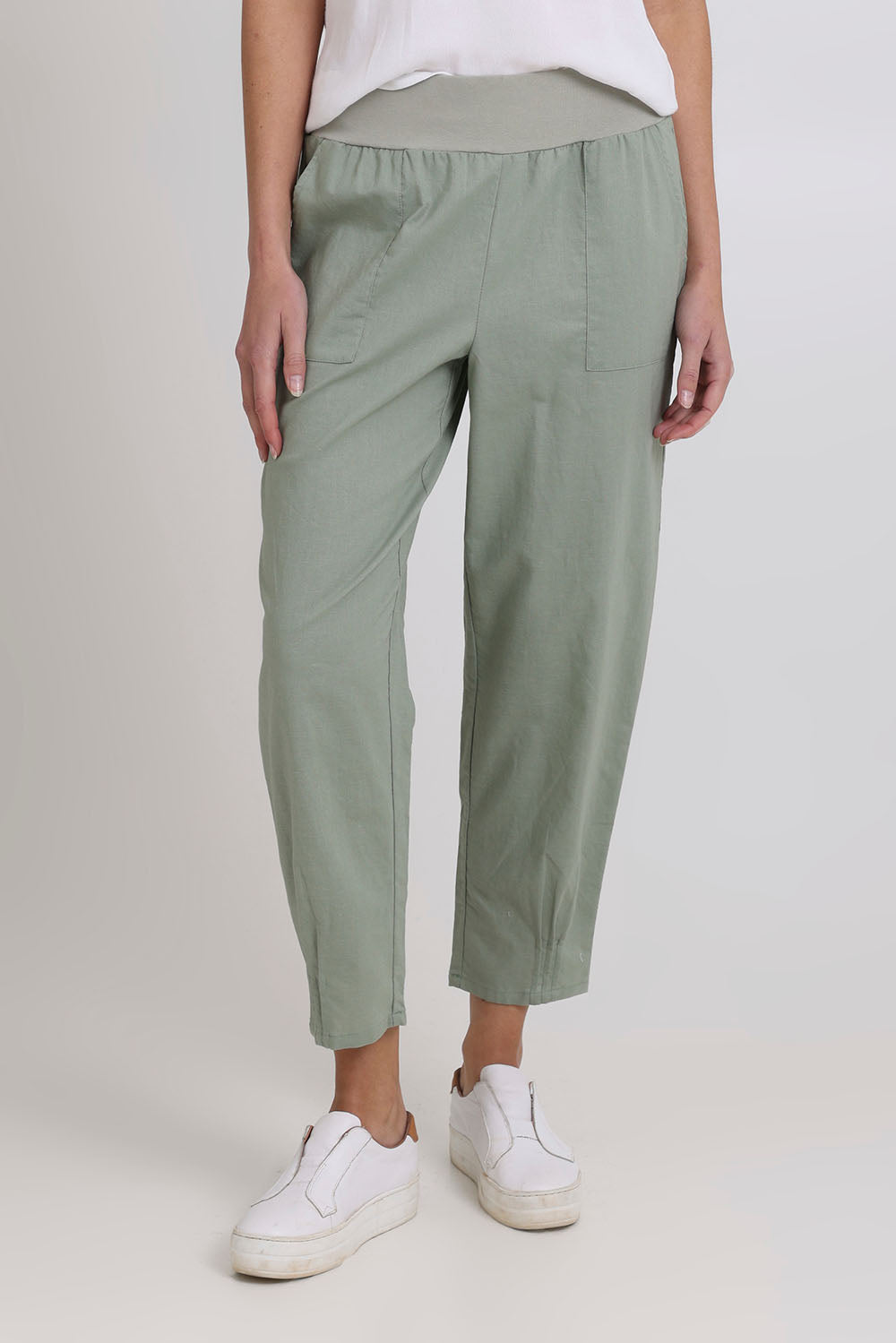 Model Madeline wearing size 10 of the Cotton Linen Comfort Pant in colour Sage (Green), from the front, cropped image
