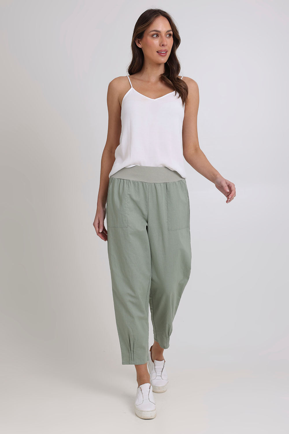Model Madeline wearing size 10 of the Cotton Linen Comfort Pant in colour Sage (Green), from the front, showing the whole outfit