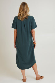 Model Grace wearing size 10 of the Top Stitch Cotton Shirt Dress in colour Forest (Green), from the back