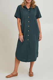 Model Grace wearing size 10 of the Top Stitch Cotton Shirt Dress in colour Forest (Green), from the front, cropped image