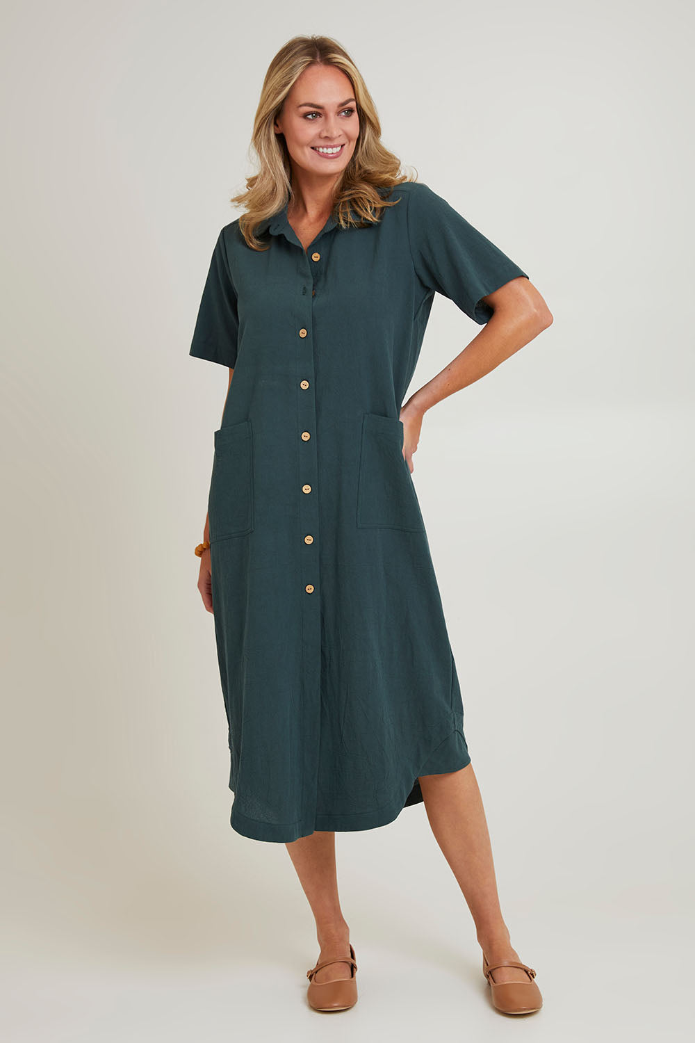 Model Grace wearing size 10 of the Top Stitch Cotton Shirt Dress in colour Forest (Green), from the front, showing the whole outfit