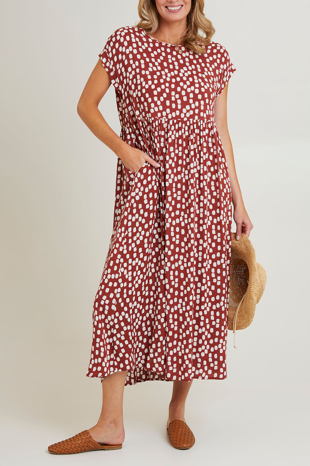 Model Grace wearing size 10 of the Teardrop Print Dress in colour Cinnamon, from the front, cropped image