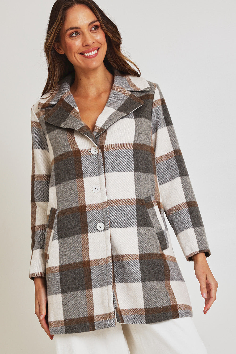 Model Madeline wearing size 10 of the Check Coat in colour Silver (Grey), from the front, cropped image