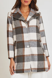 Model Madeline wearing size 10 of the Check Coat in colour Silver (Grey), from the front, cropped image