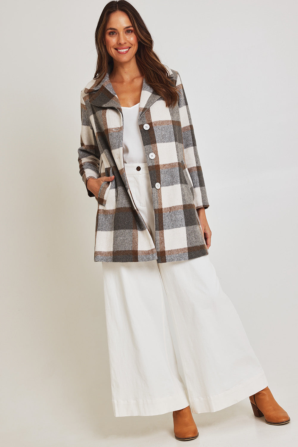 Model Madeline wearing size 10 of the Check Coat in colour Silver (Grey), from the front, showing the whole outfit