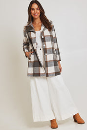 Model Madeline wearing size 10 of the Check Coat in colour Silver (Grey), from the front, showing the whole outfit