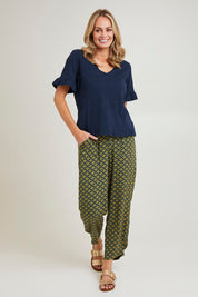 Model Grace wearing size 10 of the Java Crop Pant in colour Teal (Green), from the front, showing the whole outfit