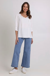 Model Madeline wearing size 10 of the Floriana Core Top in colour White (White), from the front, showing the whole outfit