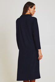 Model Madeline wearing size 10 of the Cowl Shift Dress in colour Navy (Blue), from the back
