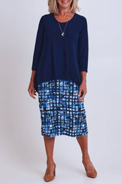 Model Sandy wearing size 10 of the Forgiveness Dress in colour Navyprint (Blue), from the front, cropped image