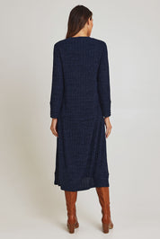 Model Madeline wearing size 10 of the Knit Core Dress in colour Navy (Blue), from the back