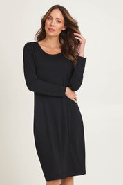 Model Madeline wearing size 10 of the Bamboo Dress in colour Black (Black), from the front, cropped image