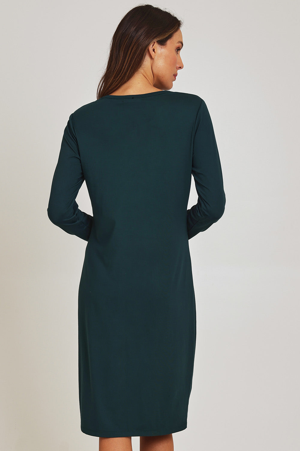 Model Madeline wearing size 10 of the Bamboo Dress in colour Forest (Green), from the back