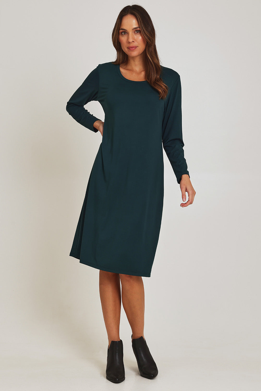 Model Madeline wearing size 10 of the Bamboo Dress in colour Forest (Green), from the front, showing the whole outfit