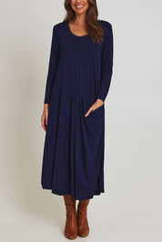 Model Madeline wearing size 10 of the Long Sleeve Pocket Dress in colour Navy (Blue), from the front, cropped image