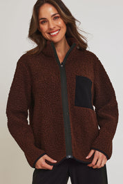 Model Madeline wearing size 10 of the Teddy Zippy Jacket in colour Choc, from the front, cropped image