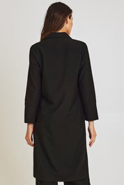 Model Madeline wearing size 10 of the Fluid Longline Jacket in colour Black (Black), from the back