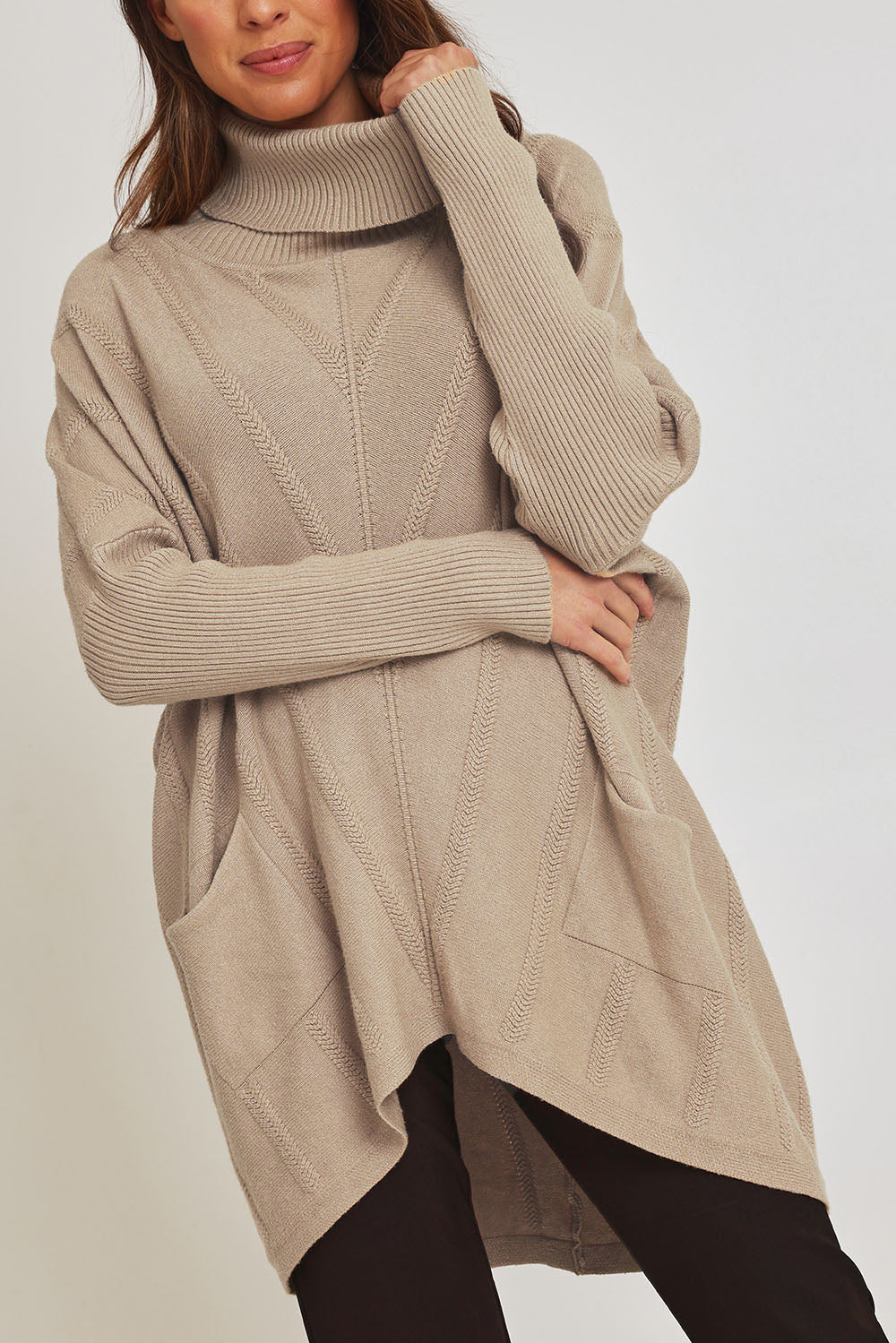 Model Madeline wearing the Polo Tunic Knit Jumper in colour Sand, from the front, cropped image