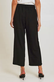Model Madeline wearing size 10 of the Fluid Pocket Pant in colour Black (Black), from the back