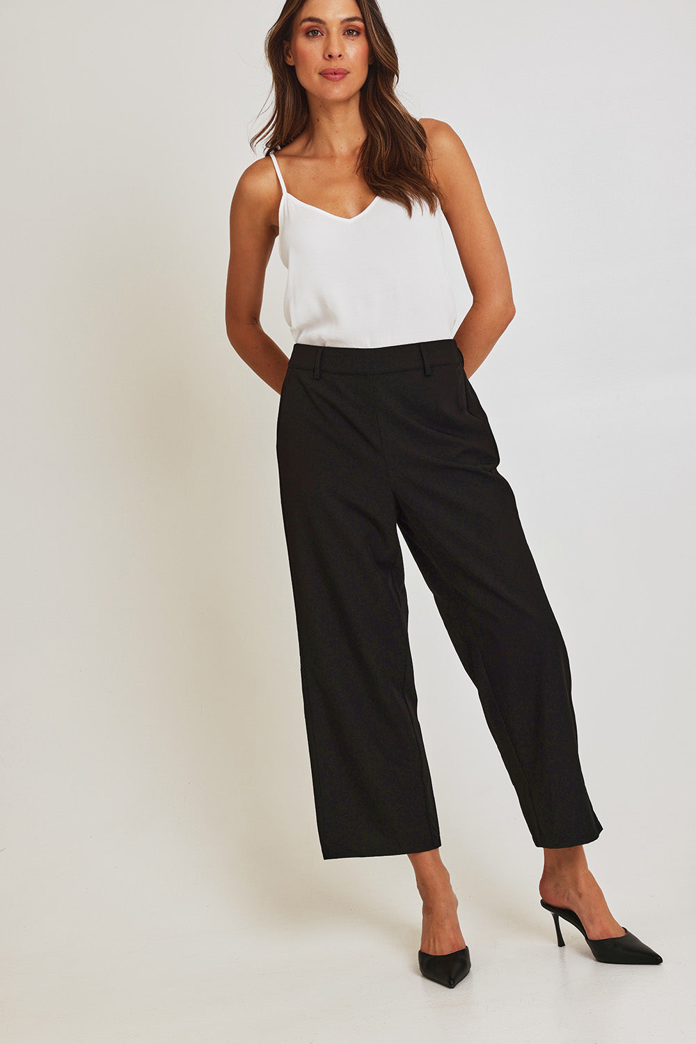 Model Madeline wearing size 10 of the Fluid Pocket Pant in colour Black (Black), from the front, showing the whole outfit