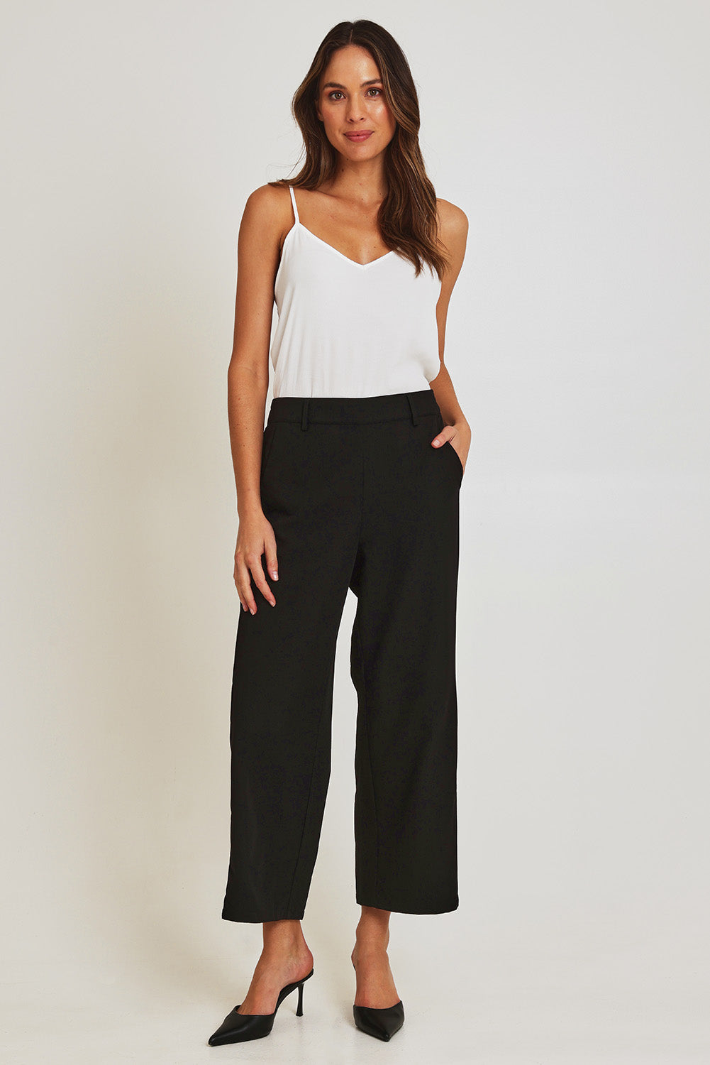 Model Madeline wearing size 10 of the Fluid Pocket Pant in colour Black (Black), from the front, showing the whole outfit