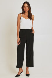 Model Madeline wearing size 10 of the Fluid Pocket Pant in colour Black (Black), from the front, showing the whole outfit