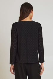 Model Madeline wearing size 10 of the Lace Broderie Top in colour Black (Black), from the back