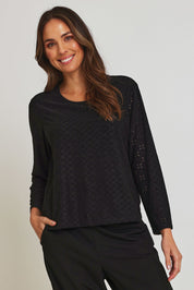 Model Madeline wearing size 10 of the Lace Broderie Top in colour Black (Black), from the front, cropped image