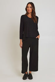 Model Madeline wearing size 10 of the Lace Broderie Top in colour Black (Black), from the front, showing the whole outfit