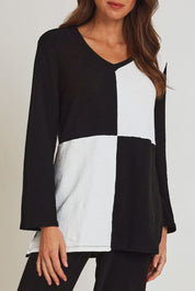 Model Madeline wearing size 10 of the Textured Splice Core Top in colour Blackivory (Black), from the front, cropped image