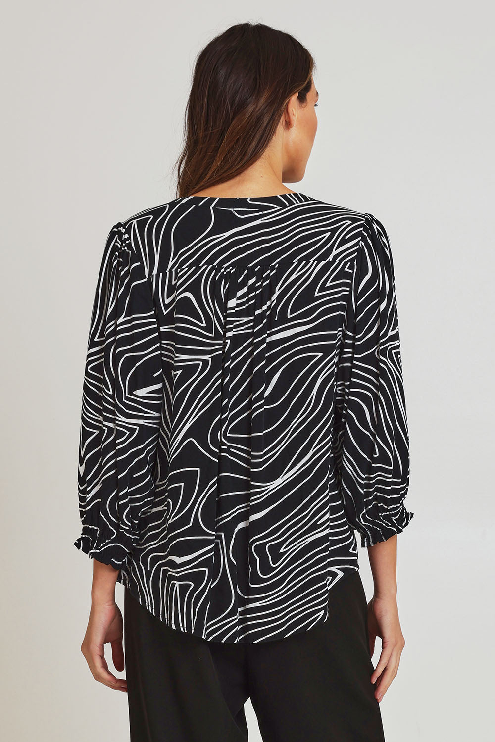 Model Madeline wearing size 10 of the Black And White Button Up Shirt in colour Blackwhite (Black), from the back