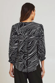 Model Madeline wearing size 10 of the Black And White Button Up Shirt in colour Blackwhite (Black), from the back