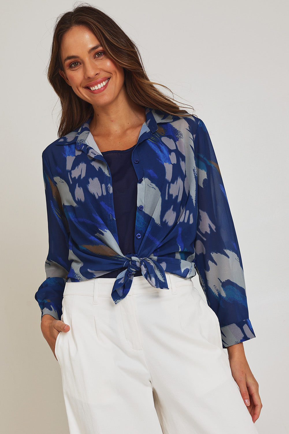 Model Madeline wearing size 10 of the Abstract Shirt in colour Blueprint (Blue), from the front, cropped image