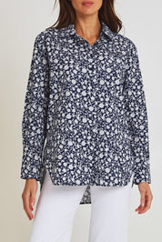 Model Madeline wearing size 10 of the Floral Scoop Cotton Shirt in colour Navywhite (Blue), from the front, cropped image