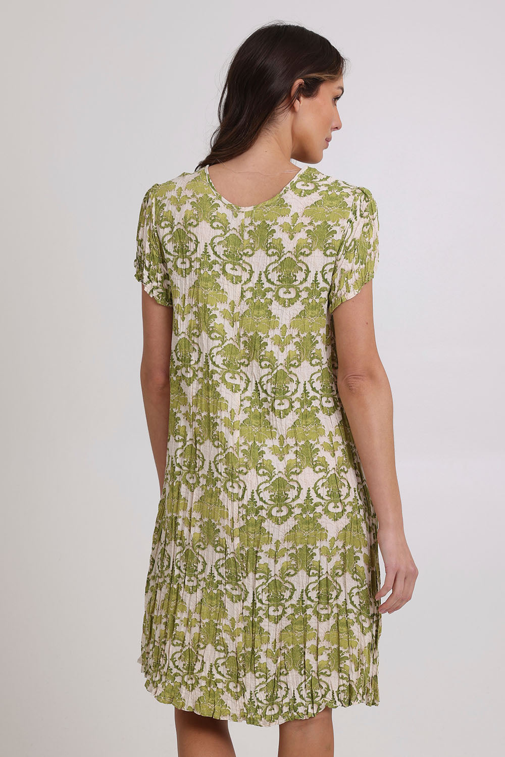 Model Madeline wearing size 10 of the Summer Sands Dress in colour Lime (Green), from the back
