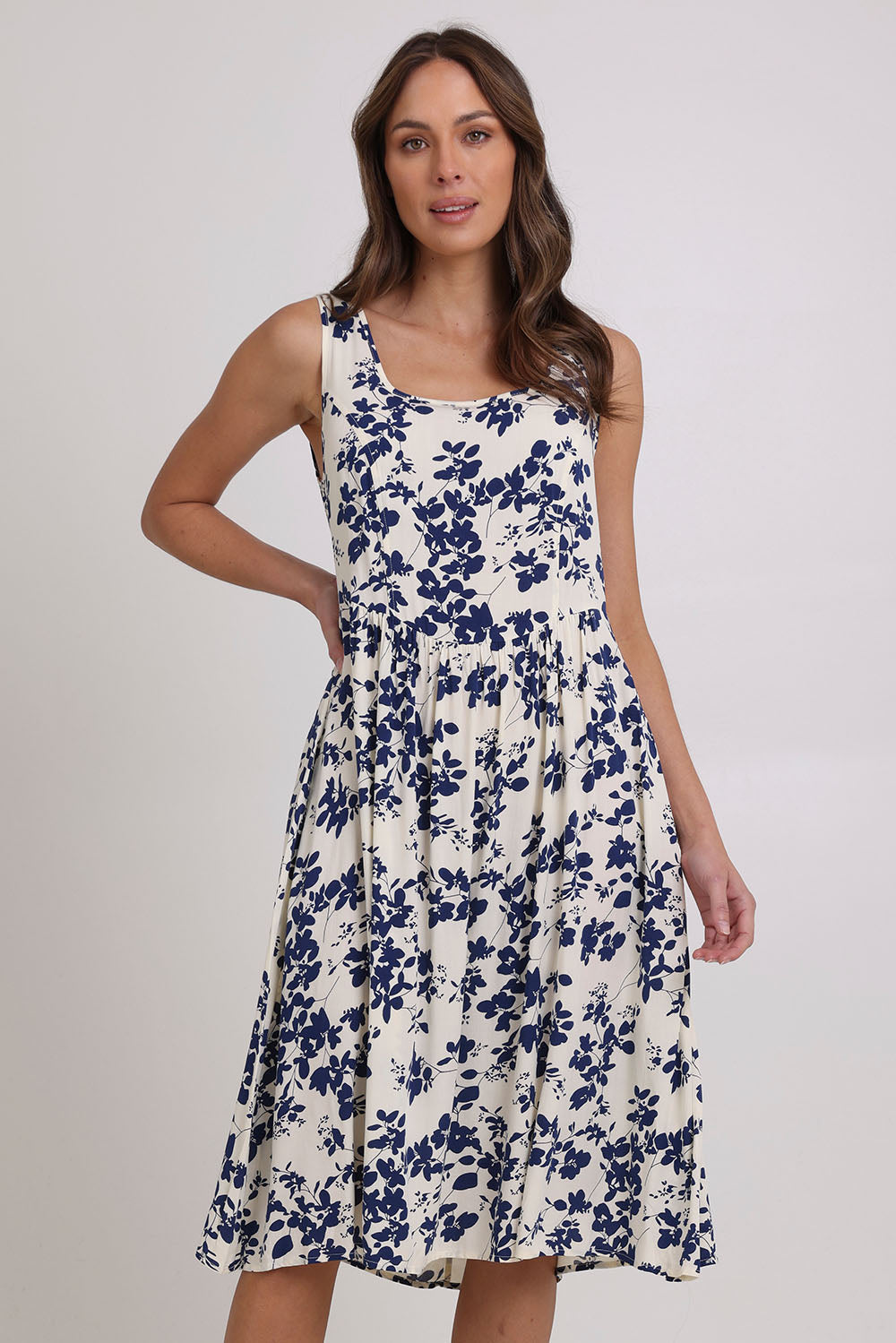 Model Madeline wearing size 10 of the Oakley Dress in colour Blue (Blue), from the front, cropped image