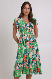 Model Madeline wearing size 10 of the Jilly Dress in colour Green (Green), from the front, cropped image