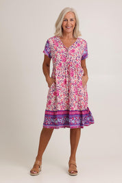 Model Sandy wearing size 10 of The Print Dress in colour Pink (Pink), from the front, showing the whole outfit