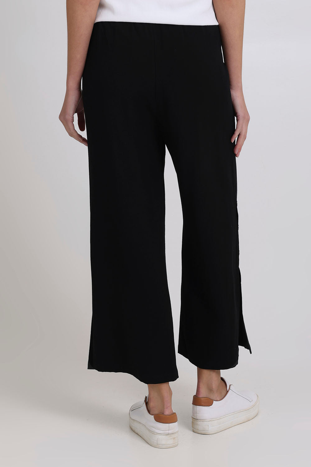 Model Madeline wearing size 10 of the Linen Shores Pant in colour Black (Black), from the back
